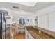 Open kitchen features granite countertops, stainless steel appliances, and bar seating for casual dining and entertaining at 9200 Midnight Pass Rd # 24, Sarasota, FL 34242