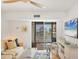 Bright living room with water views and a ceiling fan, creating a serene and comfortable atmosphere at 9200 Midnight Pass Rd # 24, Sarasota, FL 34242
