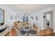 Bright living room with beachy decor, dining area, and balcony access offering a relaxing and inviting space at 9200 Midnight Pass Rd # 24, Sarasota, FL 34242