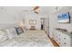 Inviting primary bedroom showcasing a comfortable bed, soft lighting, ceiling fan, and ample storage space at 9200 Midnight Pass Rd # 24, Sarasota, FL 34242