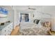 Comfortable primary bedroom featuring balcony access, cozy decor, ceiling fan, and serene waterfront views at 9200 Midnight Pass Rd # 24, Sarasota, FL 34242