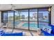 Balcony patio view overlooks a pool and waterway featuring outdoor seating and a ceiling fan for comfort at 9200 Midnight Pass Rd # 24, Sarasota, FL 34242