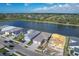 Aerial view of neighborhood showcasing lake, landscaping, and multiple single-Gathering homes on a sunny day at 10217 Canaveral Cir, Sarasota, FL 34241