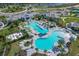 Aerial view of community pools, lounging areas, and lush landscaping on a beautiful day at 10217 Canaveral Cir, Sarasota, FL 34241