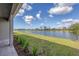 Well-manicured backyard leads to a serene waterfront view from this home at 10217 Canaveral Cir, Sarasota, FL 34241