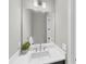 Modern bathroom featuring a sleek vanity with white countertop and a large mirror at 10217 Canaveral Cir, Sarasota, FL 34241