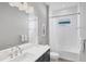 This bathroom features a double sink, and a shower/tub combo with white subway tiles at 10217 Canaveral Cir, Sarasota, FL 34241