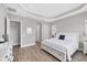 Spacious bedroom boasts trey ceiling, hardwood floors, and large entryway to ensuite bathroom at 10217 Canaveral Cir, Sarasota, FL 34241