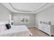 Bedroom boasts trey ceiling, hardwood floors, and a large window for lots of natural light at 10217 Canaveral Cir, Sarasota, FL 34241