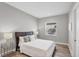 Cozy bedroom with wood floors, a bedside table, and a window providing natural light at 10217 Canaveral Cir, Sarasota, FL 34241
