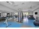 Well-equipped gym with modern fitness equipment and mirrored wall, designed for a complete workout at 10217 Canaveral Cir, Sarasota, FL 34241