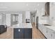Modern kitchen featuring a center island with white countertops and gray cabinets and stainless steel appliances at 10217 Canaveral Cir, Sarasota, FL 34241