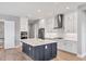Modern kitchen features stainless steel appliances, dark island with marble countertop, and pendant lighting at 10217 Canaveral Cir, Sarasota, FL 34241
