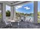 Inviting outdoor patio with comfortable seating, offering views of the refreshing pool area at 10217 Canaveral Cir, Sarasota, FL 34241