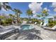 Community hot tub surrounded by lounge chairs and lush palm trees at 10217 Canaveral Cir, Sarasota, FL 34241