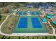 Aerial view of meticulously maintained tennis courts in a beautiful community setting at 10217 Canaveral Cir, Sarasota, FL 34241