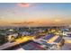Beautiful aerial view of community featuring tennis courts, landscape, and sunset at 1050 Longboat Club Road # 903, Longboat Key, FL 34228
