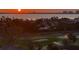 Sunset aerial view showcasing the golf course, coastline, and city skyline at 1050 Longboat Club Road # 903, Longboat Key, FL 34228