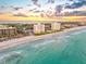 Coastal aerial showcasing beachfront buildings with ocean views, sandy beaches, and clear turquoise waters at 1050 Longboat Club Road # 903, Longboat Key, FL 34228