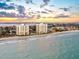 Scenic view of coastal buildings on sandy shore with clear waters and a picturesque sunset backdrop at 1050 Longboat Club Road # 903, Longboat Key, FL 34228