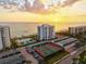 Aerial view of beachfront community with a pool, tennis courts, and ample parking at 1050 Longboat Club Road # 903, Longboat Key, FL 34228