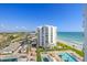 Aerial view of a condo building with a pool, beach access, and convenient parking at 1050 Longboat Club Road # 903, Longboat Key, FL 34228