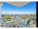 Relaxing balcony with comfortable seating, offering a panoramic view of the surrounding landscape and blue skies at 1050 Longboat Club Road # 903, Longboat Key, FL 34228