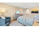 Bedroom features neutral decor, sliders to balcony with a water view, dresser, and ceiling fan at 1050 Longboat Club Road # 903, Longboat Key, FL 34228