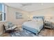 Bright bedroom featuring a comfortable bed with blue accents and a ceiling fan for added comfort at 1050 Longboat Club Road # 903, Longboat Key, FL 34228