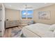 Bedroom with large windows offering water views, a ceiling fan and stylish decor with soothing color palette at 1050 Longboat Club Road # 903, Longboat Key, FL 34228