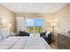 Cozy bedroom features neutral decor, sliders to balcony with a golf course view, dresser, and side tables at 1050 Longboat Club Road # 903, Longboat Key, FL 34228