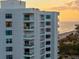 A well-maintained white condo building by the beach, featuring balconies and stunning views at 1050 Longboat Club Road # 903, Longboat Key, FL 34228