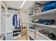 Custom walk-in closet with ample shelving and hanging space for organization at 1050 Longboat Club Road # 903, Longboat Key, FL 34228