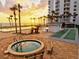 Resort-style oceanfront pool, hot tub, and shuffleboard with stunning sunset views at 1050 Longboat Club Road # 903, Longboat Key, FL 34228