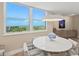 Bright dining area with a large window, ocean view, and elegant table setting at 1050 Longboat Club Road # 903, Longboat Key, FL 34228