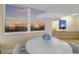 Inviting dining room featuring a sunset view, a round table, and contemporary lighting fixtures at 1050 Longboat Club Road # 903, Longboat Key, FL 34228