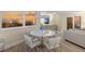 This dining room is well-lit with sunset views, a modern round table and stylish, comfortable chairs at 1050 Longboat Club Road # 903, Longboat Key, FL 34228