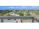 Stunning golf course community view featuring modern architecture, lush landscaping, and a tennis court at 1050 Longboat Club Road # 903, Longboat Key, FL 34228