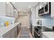 Modern kitchen with stainless appliances, quartz countertops, and sleek cabinetry at 1050 Longboat Club Road # 903, Longboat Key, FL 34228