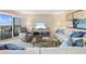 Bright living room featuring stylish furniture, a glass coffee table, and sliding doors to a scenic balcony at 1050 Longboat Club Road # 903, Longboat Key, FL 34228