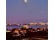 City lights and a full moon illuminate this coastal cityscape at 1050 Longboat Club Road # 903, Longboat Key, FL 34228