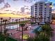 Resort-style pool area with palm trees and ocean views offering a luxurious beachfront lifestyle at 1050 Longboat Club Road # 903, Longboat Key, FL 34228