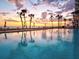 Enjoy the community pool with beach access, chairs, and umbrellas in a tropical setting at 1050 Longboat Club Road # 903, Longboat Key, FL 34228