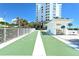 Outdoor shuffleboard court with view of building and surrounding green spaces at 1050 Longboat Club Road # 903, Longboat Key, FL 34228