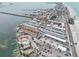 Stunning aerial view of beachside condos with pools, parking, and gulf access via a pier, capturing coastal living at its finest at 117 7Th N St # 5, Bradenton Beach, FL 34217
