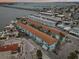 Aerial view of a condo complex with multiple pools and bridge in the background at 117 7Th N St # 5, Bradenton Beach, FL 34217