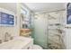 Stylish bathroom featuring a glass shower door, shelving, and modern fixtures at 117 7Th N St # 5, Bradenton Beach, FL 34217