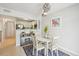 Cozy dining area with white table and chairs, adjacent to a modern kitchen at 117 7Th N St # 5, Bradenton Beach, FL 34217