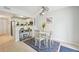 The dining room is connected to the kitchen and features white chairs and a patterned rug at 117 7Th N St # 5, Bradenton Beach, FL 34217