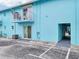 Turquoise building exterior with a balcony and sliding glass door at 117 7Th N St # 5, Bradenton Beach, FL 34217